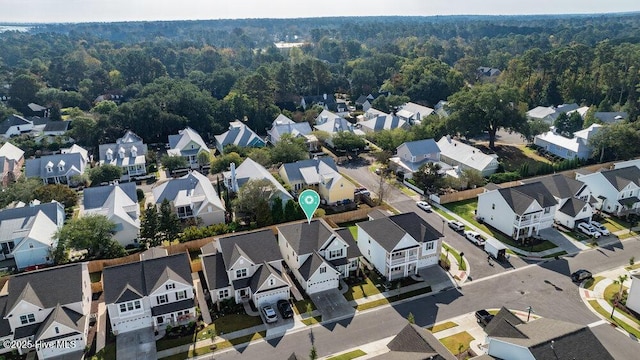 birds eye view of property with a residential view and a view of trees