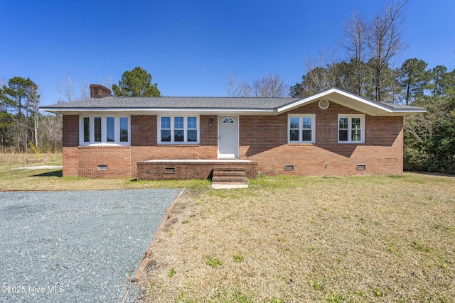 ranch-style house with crawl space, brick siding, a chimney, and a front yard