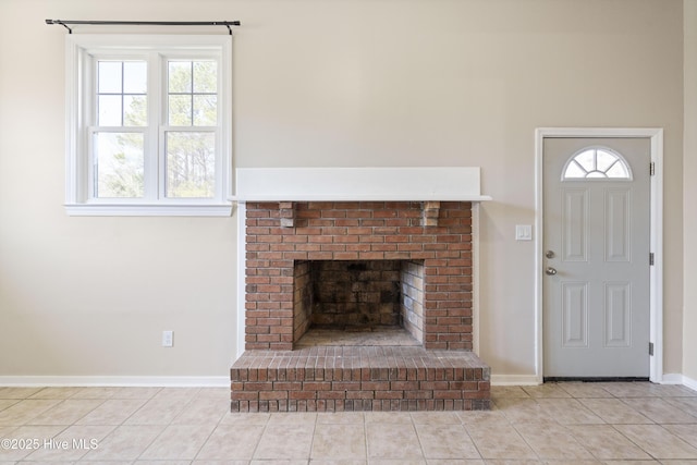 unfurnished living room featuring tile patterned floors, baseboards, and a brick fireplace