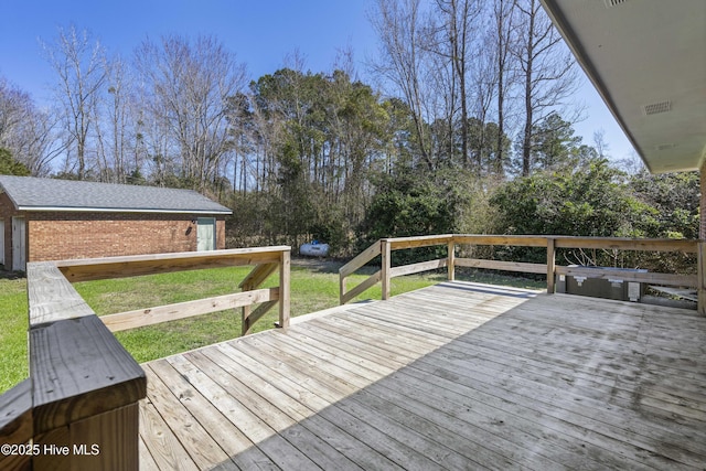 deck featuring an outbuilding and a lawn