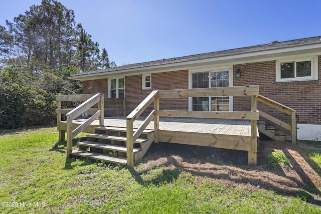 back of property featuring brick siding and a wooden deck