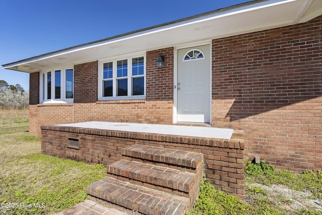 property entrance with brick siding