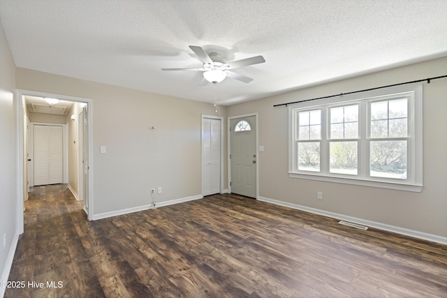 foyer featuring dark wood finished floors, a ceiling fan, and baseboards