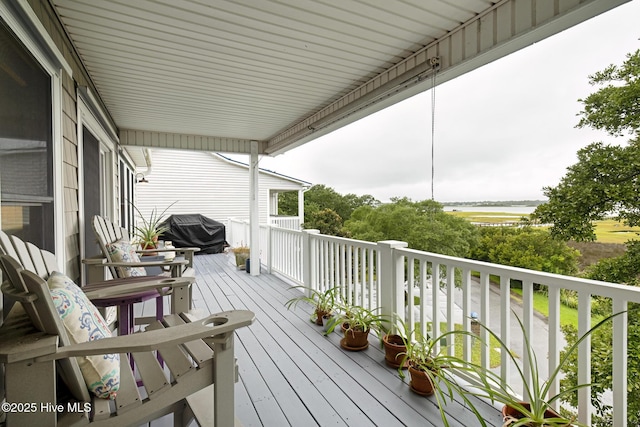 wooden deck featuring a grill