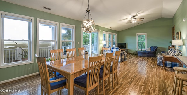 dining room featuring visible vents, wood finished floors, a ceiling fan, and vaulted ceiling