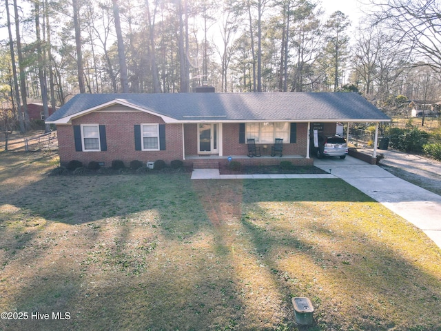 single story home with a carport, a front yard, brick siding, and driveway