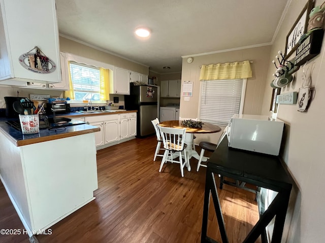 kitchen featuring separate washer and dryer, freestanding refrigerator, dark wood-type flooring, white cabinetry, and crown molding