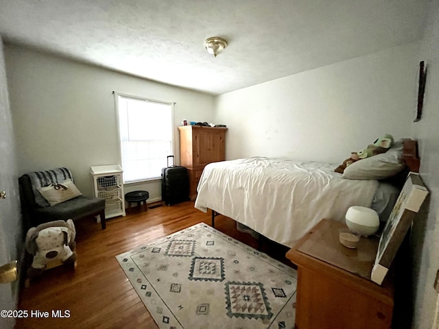 bedroom featuring wood finished floors