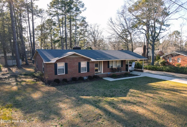 ranch-style home with brick siding, a porch, concrete driveway, a front yard, and a carport