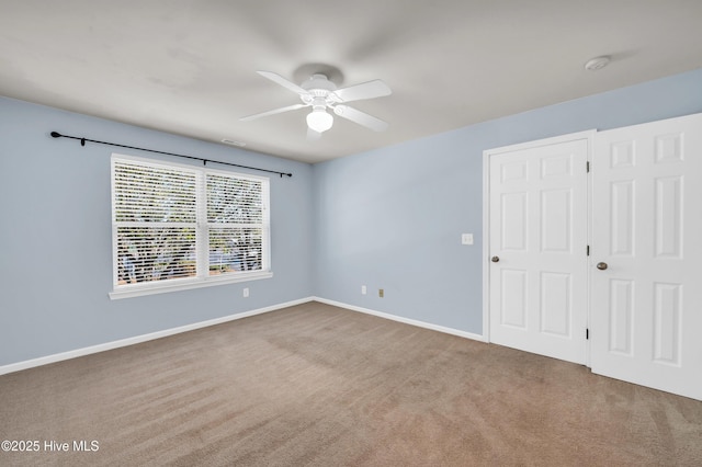 unfurnished bedroom featuring visible vents, a ceiling fan, baseboards, and carpet floors