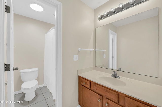 bathroom featuring tile patterned flooring, toilet, vanity, and baseboards