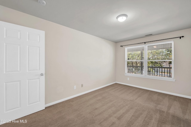 unfurnished room featuring visible vents, baseboards, and carpet