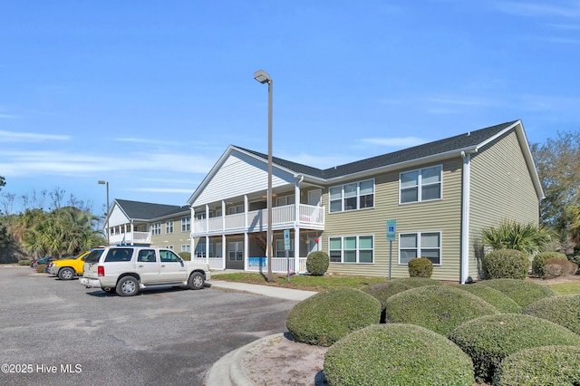 view of building exterior featuring uncovered parking