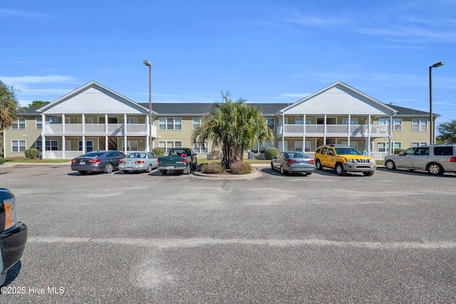 view of property featuring a residential view and uncovered parking