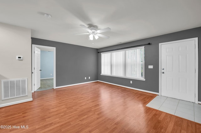 entrance foyer with light wood-style flooring, baseboards, visible vents, and ceiling fan