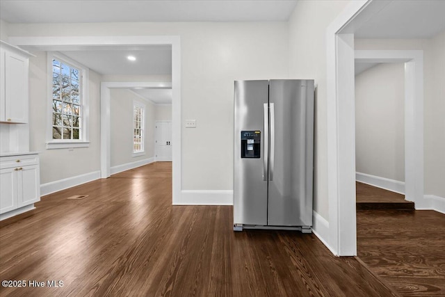 interior space featuring baseboards and dark wood-style flooring