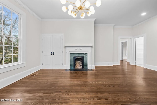 unfurnished living room with a notable chandelier, visible vents, wood finished floors, and ornamental molding