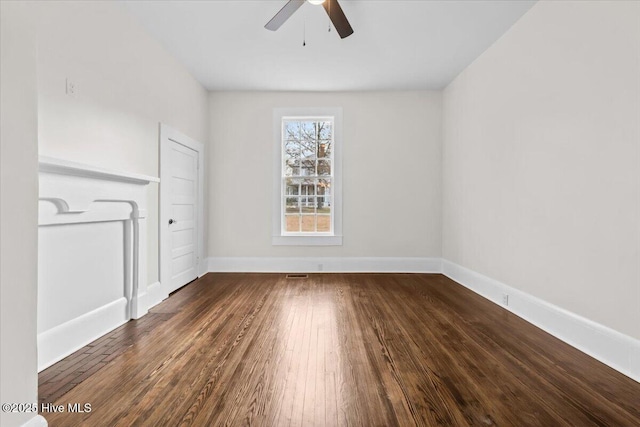 empty room with hardwood / wood-style floors, baseboards, and ceiling fan