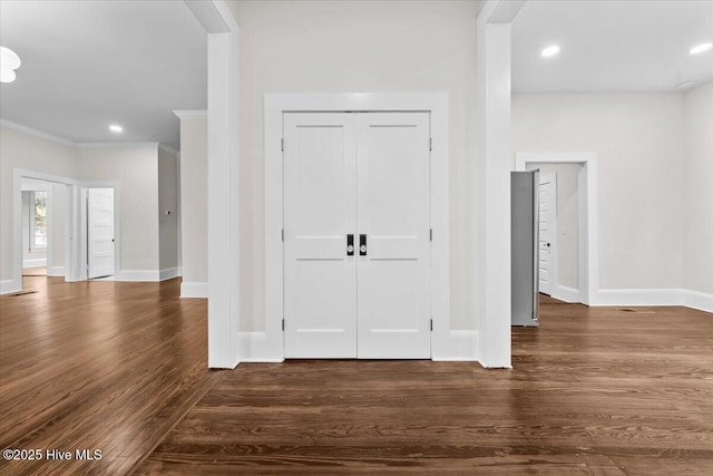 foyer entrance with baseboards, dark wood-style flooring, and ornamental molding