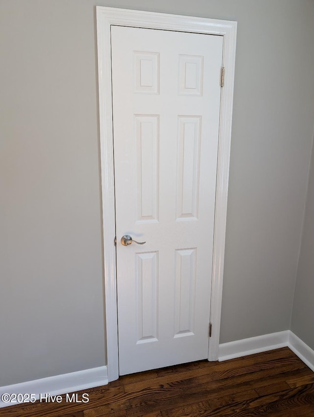 interior details featuring wood finished floors and baseboards