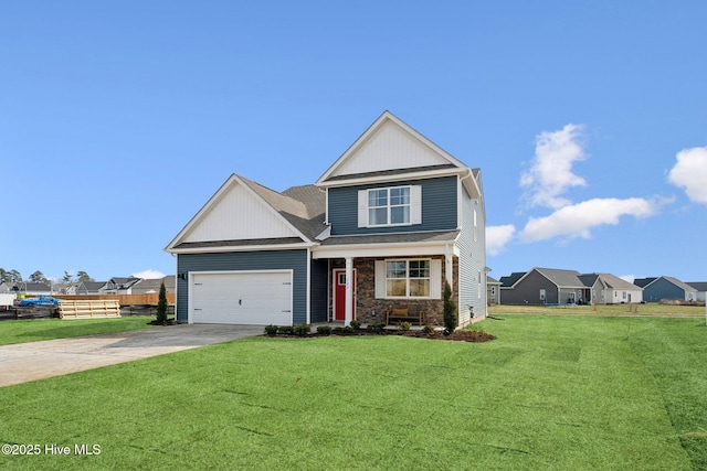 craftsman house with a front yard, fence, driveway, an attached garage, and stone siding