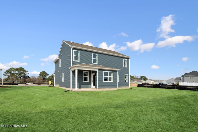 back of house with a patio area, a lawn, roof with shingles, and fence