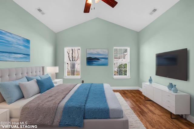 bedroom with visible vents, multiple windows, and wood finished floors