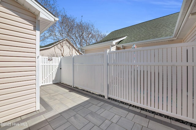 view of patio featuring a gate and fence