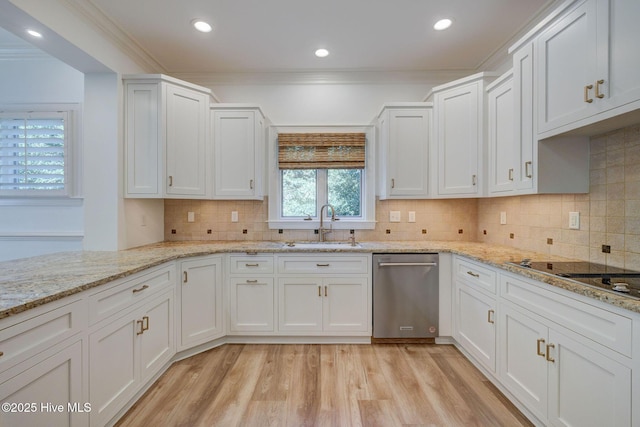 kitchen with a sink, white cabinets, light wood-style floors, stainless steel dishwasher, and crown molding