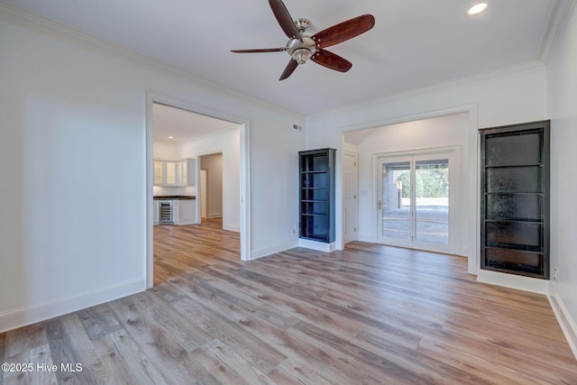 unfurnished living room featuring crown molding, light wood-style flooring, and ceiling fan