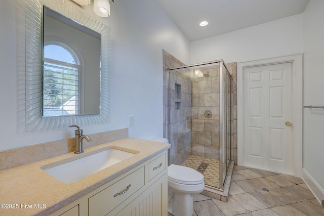 full bath featuring vanity, a shower stall, toilet, and tile patterned floors