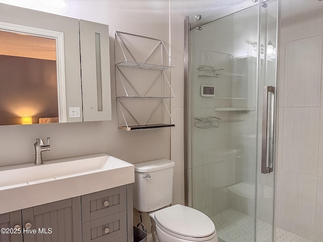 bathroom featuring a shower stall, toilet, and vanity