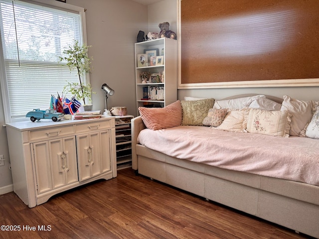 bedroom with dark wood-style flooring