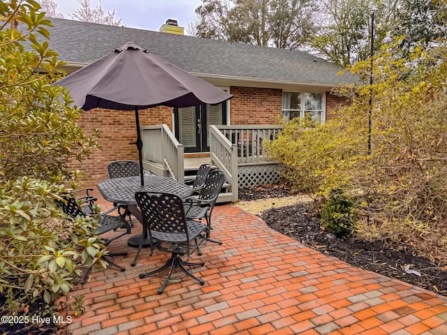 view of patio with outdoor dining area and a wooden deck