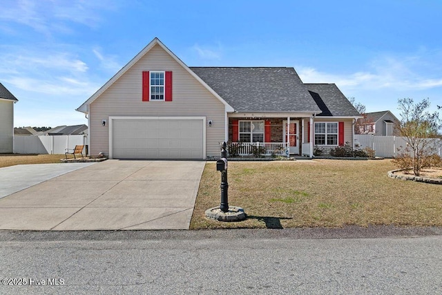 traditional-style house with a porch, concrete driveway, a front yard, and fence