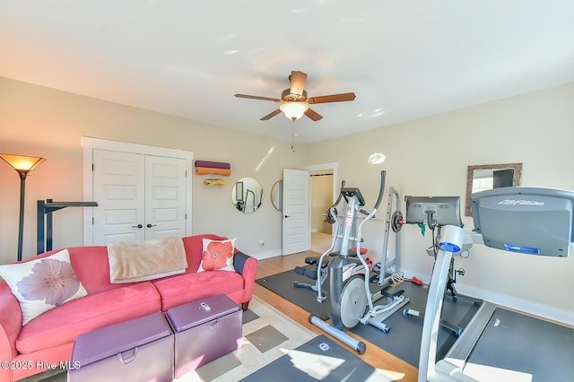 workout area featuring baseboards and ceiling fan