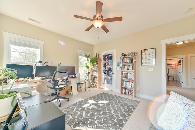 office space with visible vents and a ceiling fan