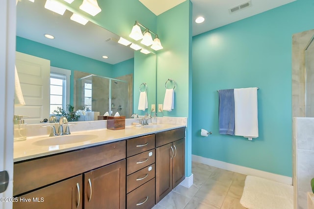 bathroom with baseboards, visible vents, double vanity, a sink, and a shower stall