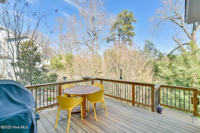 wooden deck featuring a grill