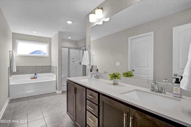 full bath featuring tile patterned floors, a garden tub, a shower stall, and a sink