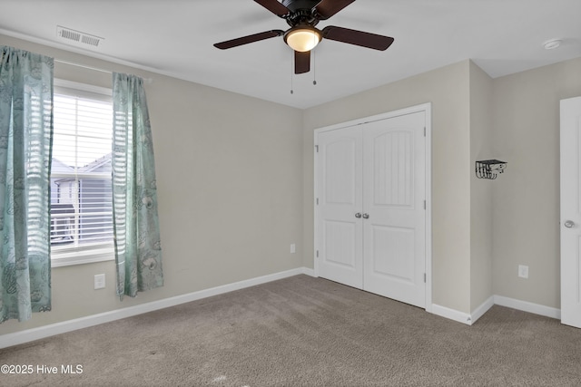 unfurnished bedroom with visible vents, ceiling fan, baseboards, carpet floors, and a closet