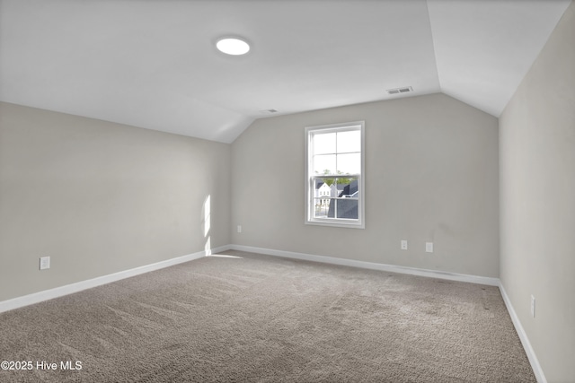 bonus room featuring vaulted ceiling, visible vents, baseboards, and carpet floors