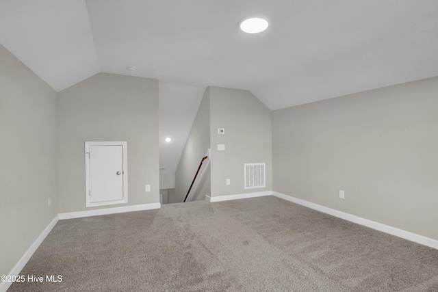 bonus room with visible vents, carpet floors, baseboards, and vaulted ceiling