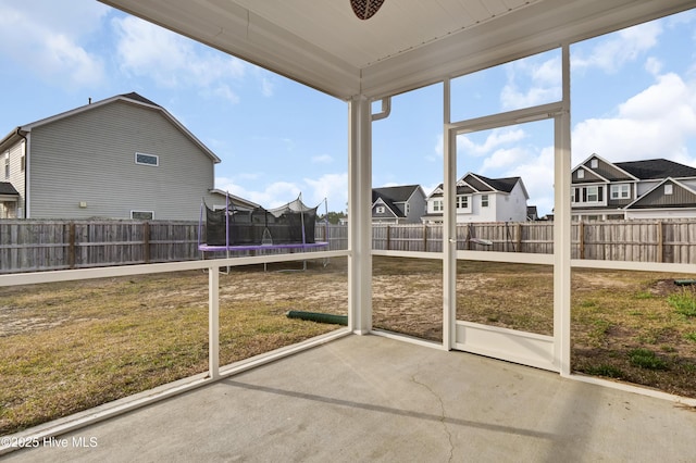 unfurnished sunroom with a residential view