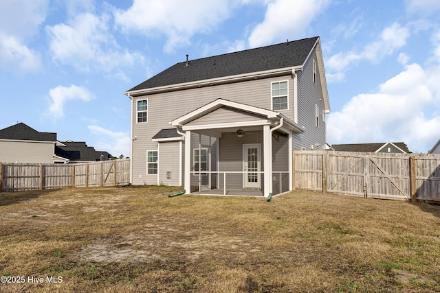 back of property featuring a fenced backyard, a lawn, a sunroom, and ceiling fan