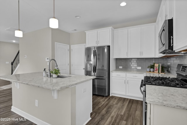 kitchen featuring a sink, stainless steel appliances, tasteful backsplash, and dark wood-style flooring