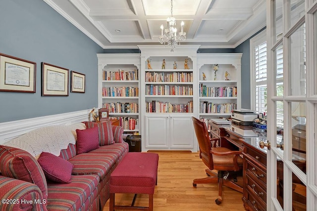 office space featuring coffered ceiling, crown molding, light wood-style flooring, and a notable chandelier