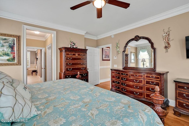 bedroom featuring ceiling fan, wood finished floors, baseboards, and ornamental molding