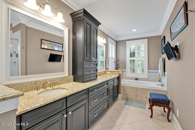 full bathroom featuring double vanity, tile patterned floors, a garden tub, and a sink