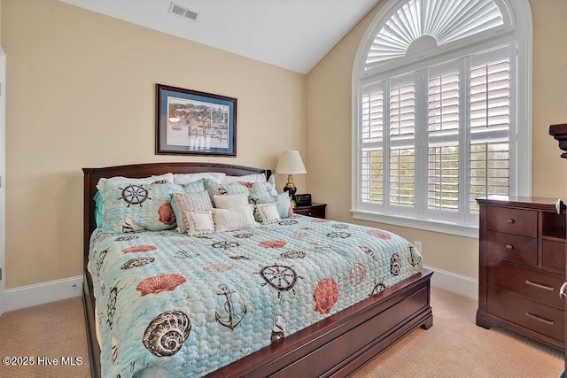 bedroom featuring baseboards, lofted ceiling, visible vents, and carpet